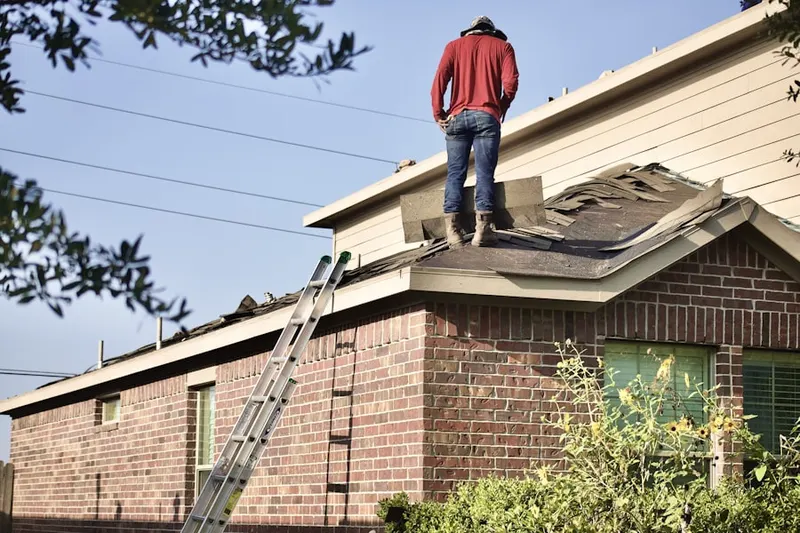 Professional roofer working on a residential roof in Greate Bay Country Club